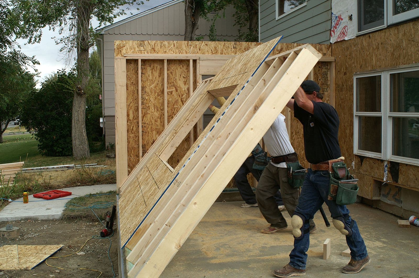 contractor putting up wall for home addition